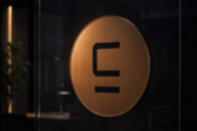 The Sigil Logic mark in brass on a glass door